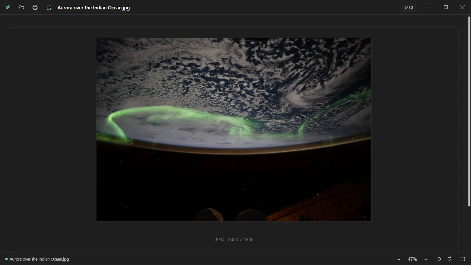 A photograph of the aurora from orbit, fitted to the window.